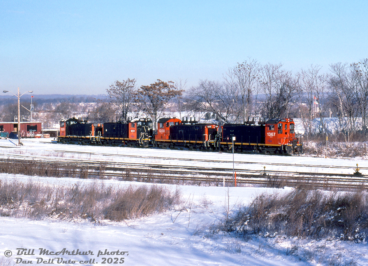 Some of Southern Ontario RaiLink's small fleet of switchers congregate in the SOR/CN Stuart Street yard awaiting their next assignments. Units shown are ex-CN SW1200RS 1367, 1359, 1201 (renumbered ex-CN 1335), and 1285. There were a few other switchers SOR owned, including 1311 (derelict, scrapped 2001), 1348 (bent frame, scrapped 2005), and the oddball ex-SW13B 1200 (scrapped 2008). 

1367 was transferred to an operation in the US in 2005, and 1201, 1285 & 1359 remained on the SOR, although by the mid-late 2000's most were out of service and stored (1359 was reactivated in 2008). All three remaining SW1200RS units were sold to LDS around 2010-2011, who overhauled them and sold them off.

Bill McArthur photo, Dan Dell'Unto collection slide.