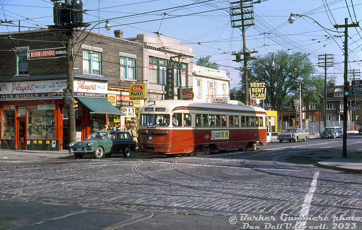 TTC PCC 4107 (A1 class, CC&F 1938) heads southbound on Dundas Street West stopped at Bloor Street West, operating on a King streetcar run heading for Church Street.This view shows the northwest corner of Dundas and Bloor, featuring Al's Smokes & Gifts (try their Player's Mild), Bloor & Dundas Hardware (selling CIL Paints), a restaurant/billiards bar, and a pharmacy. The yellow building is a new Hertz Rent-a-Car shop (built where a house used to be) and beyond that is the new Dundas West Subway Station building under construction, for the new crosstown Bloor-Danforth subway line (opened February next year). Where the station is used to be the St. Joan of Arc Church (SW corner of Dundas & Edna). It was demolished in early 60's the subway station, and moved to a new church at 1701 Bloor St. W.)Compare this with a "Time Machine" photo from 1980: http://www.railpictures.ca/?attachment_id=53600. The block at the northwest corner was boarded up in the late 2000's for a condo development that, a decade and a half later, still hasn't been built.Barker Gummere photo, Dan Dell'Unto collection slide.