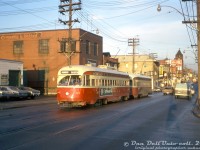 TTC PCC 4472 (A7-class, CC&F 1949) heads westbound on Queen Street East at the East Don Roadway (just east of the <a href=http://www.railpictures.ca/?attachment_id=48189><b>Don River bridge</b></a>), MU'ed with another 4400-series in Queen service. They are both passing the old Coleman Lamp and Stove Company building (still there today, at 580 Queen St. E), and another building marked "Acme Surplus Sales".<br><br>After streetcar service on Bloor and Danforth ended with the opening of the new subway, the 4400- and 4600-series streetcars retained their MU couplers and were redeployed on other busy streetcar routes, such as Queen.<br><br><i>Original photographer unknown (possibly John H. Eagle), Dan Dell'Unto collection slide.</i>