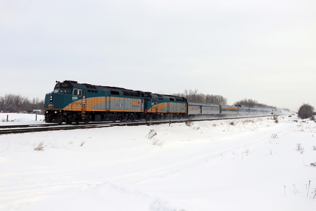 Scheduled to leave Edmonton just after midnight, VIA No. 1, the Canadian, makes a rare daylight appearance on the Edson sub running over 10 hours late. Twelve cars, including three domes, are a fine sight led by F40s 6455 and 6415.