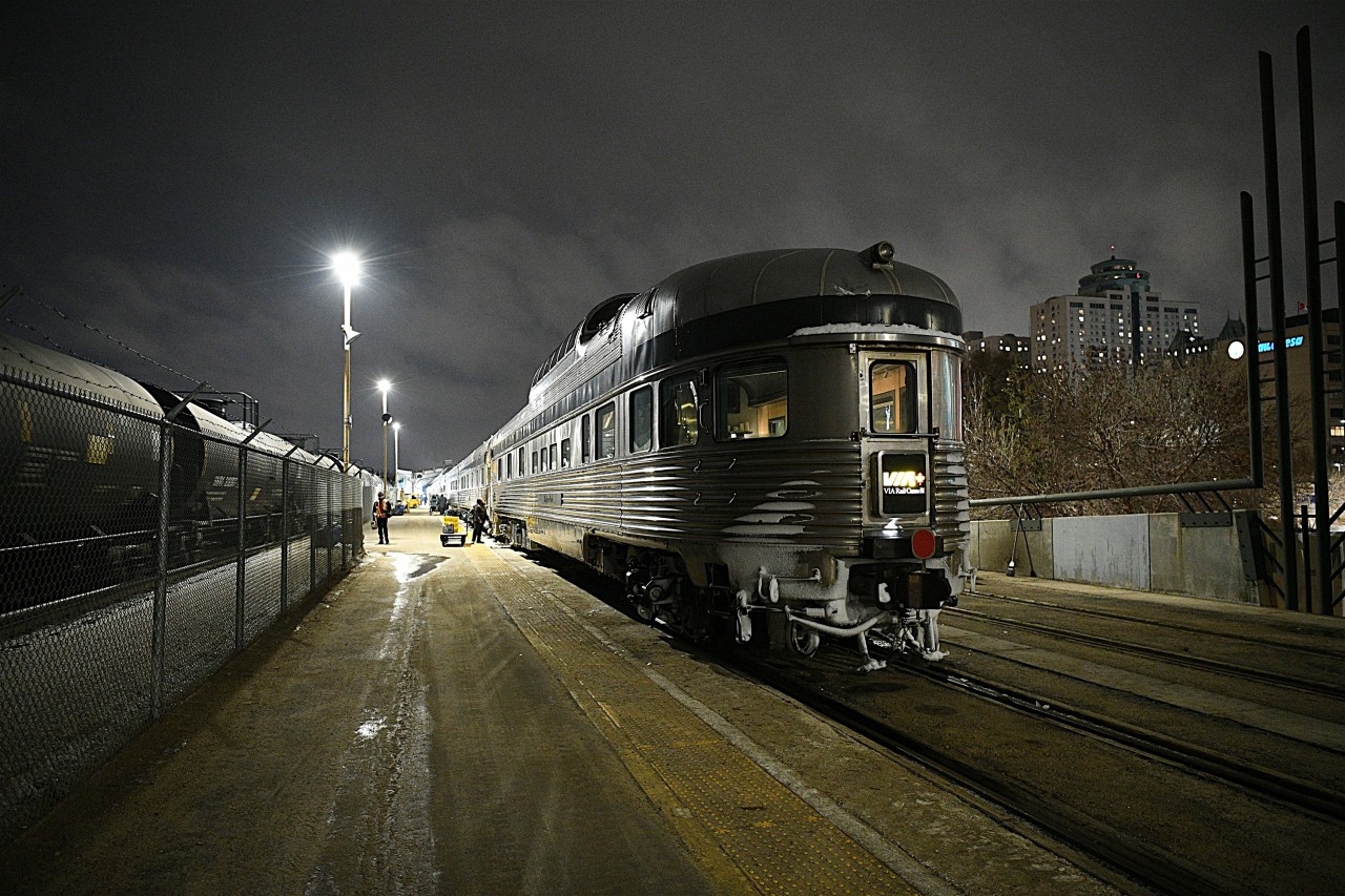 Hustle & Bustle  
VIA #1 The Canadian has arrived at Winnipeg Union Station train shed and the platform is buzzing with activity as personnel begin a complete service of the consist. Old laundry and garbage being set off, new linens and food supply being loaded. Water tanks being filled, toilet holding tanks being drained. 
VIA 88706 Glacier Park brings up the rear of the shiny Budd consist at Mile 252.1 of CN's Redditt Sub.