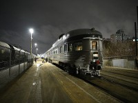 <b> Hustle & Bustle </b> <br>
VIA #1 The Canadian has arrived at Winnipeg Union Station train shed and the platform is buzzing with activity as personnel begin a complete service of the consist. Old laundry and garbage being set off, new linens and food supply being loaded. Water tanks being filled, toilet holding tanks being drained. <br>
VIA 88706 Glacier Park brings up the rear of the shiny Budd consist at Mile 252.1 of CN's Redditt Sub.