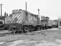 <br>
<br>
A moment in time: branchline power.
<br>
<br>
MLW 1957 built RS-18 CP Rail #8730; GMD 1959 built SW1200RS CP Rail #8142 plus unknown ALCO 194x built #7xxx. 
<br>
<br>
CP Rail 8142 to Black River & Western in 1999. Most RS-18 rebuilt in the 1800 series 1980 to 1989.
<br>
<br>
Note the fuel storage in the background, the furnace oil tank for the crew shanty and the vertical fuel tank behind the van.
<br>
<br>
At CP Rail Woodstock, January 21, 1980 Kodak Tri X negative by S.Danko.